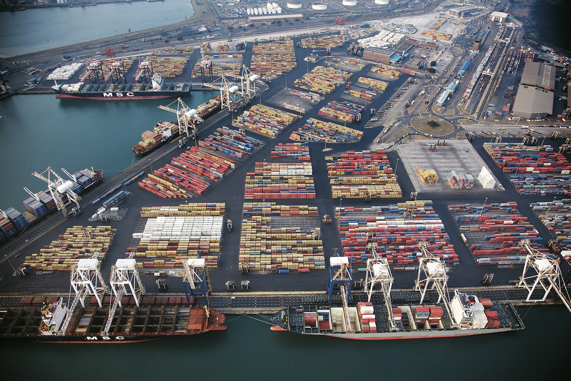 Stacked shipping containers and cranes at Durban port