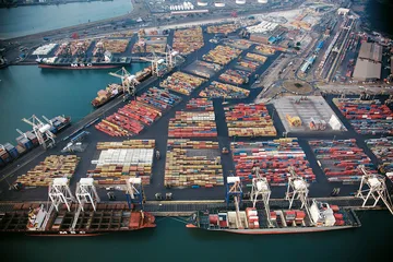 Stacked shipping containers and cranes at Durban port